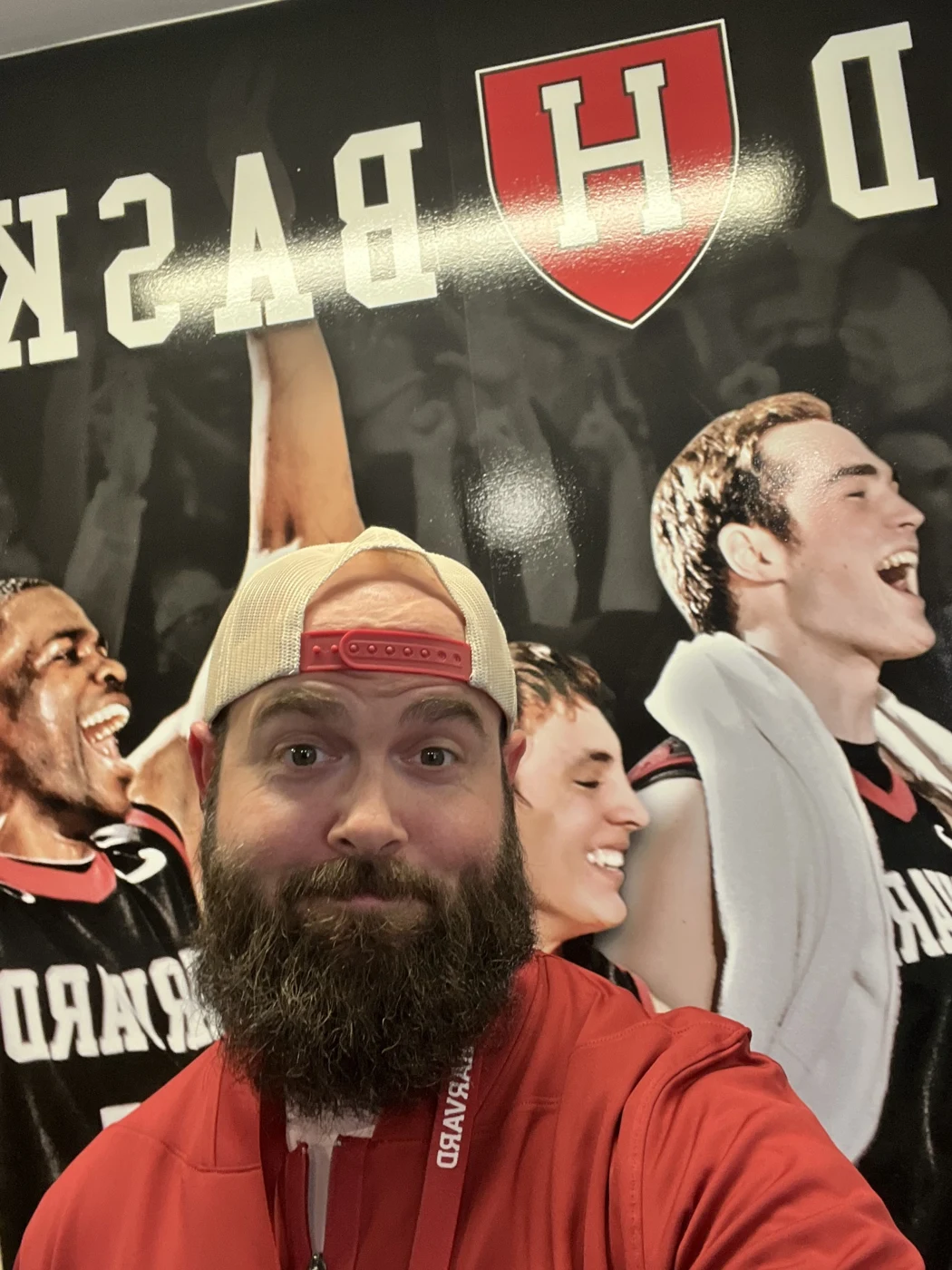 Kyle in headphones at a Harvard basketball display