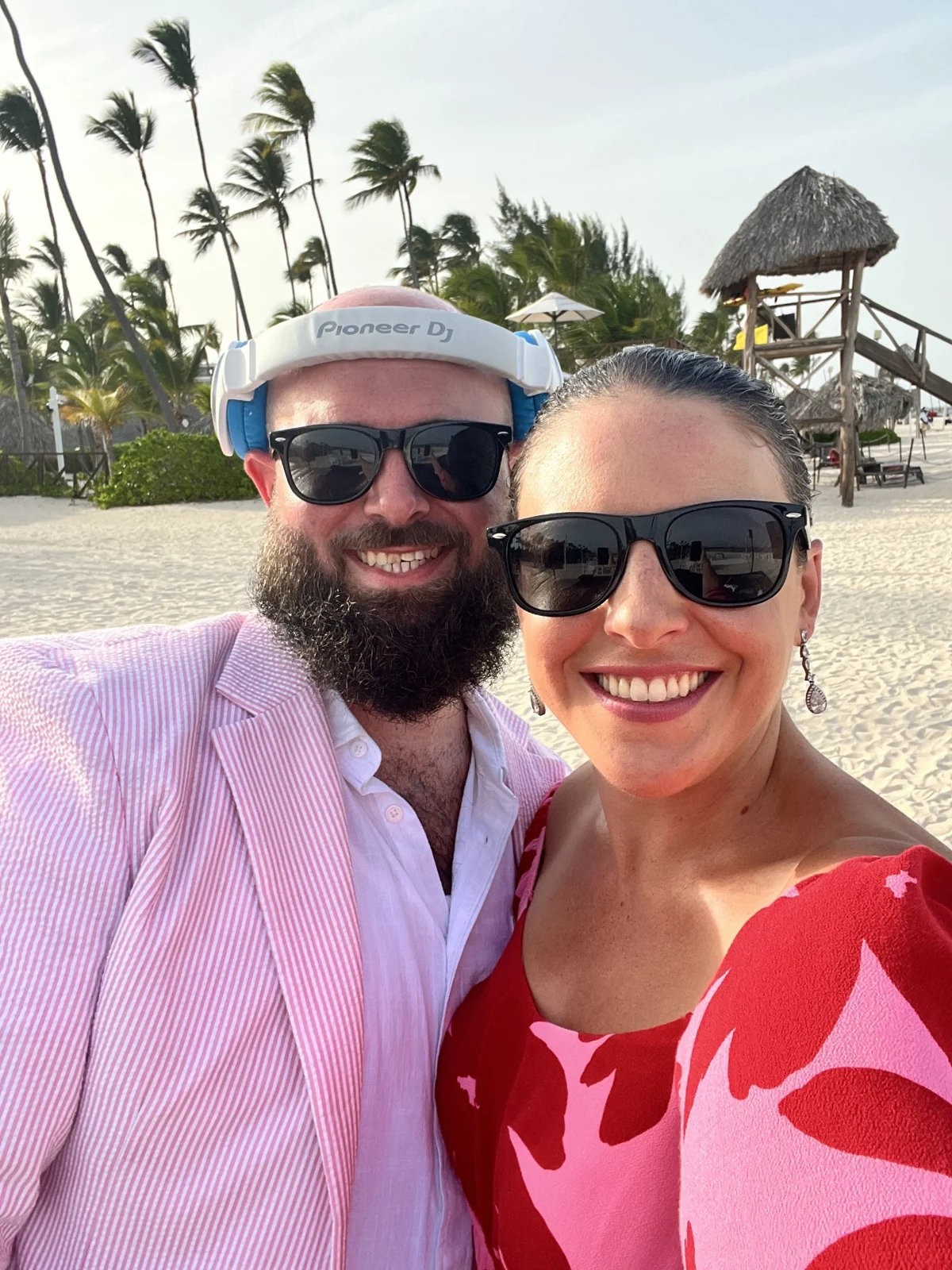 Kyle and his wife smiling together at a beach celebration