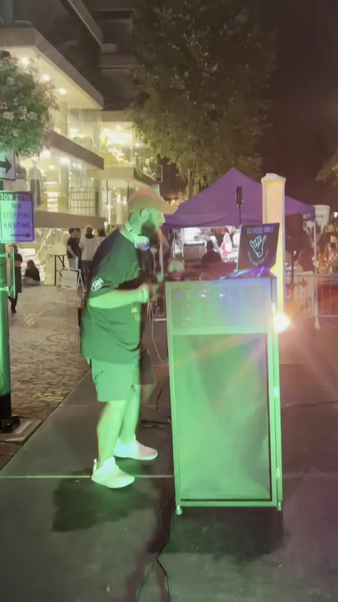 Kyle performing at an outdoor community night market