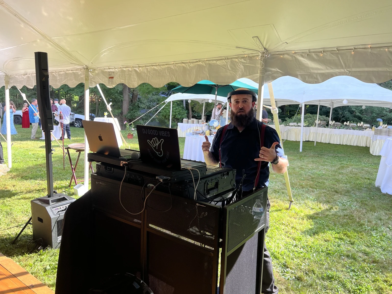 DJ Good Vibes under a tent at an outdoor celebration